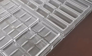 Clear chocolate molds made from polycarbonate plastic.