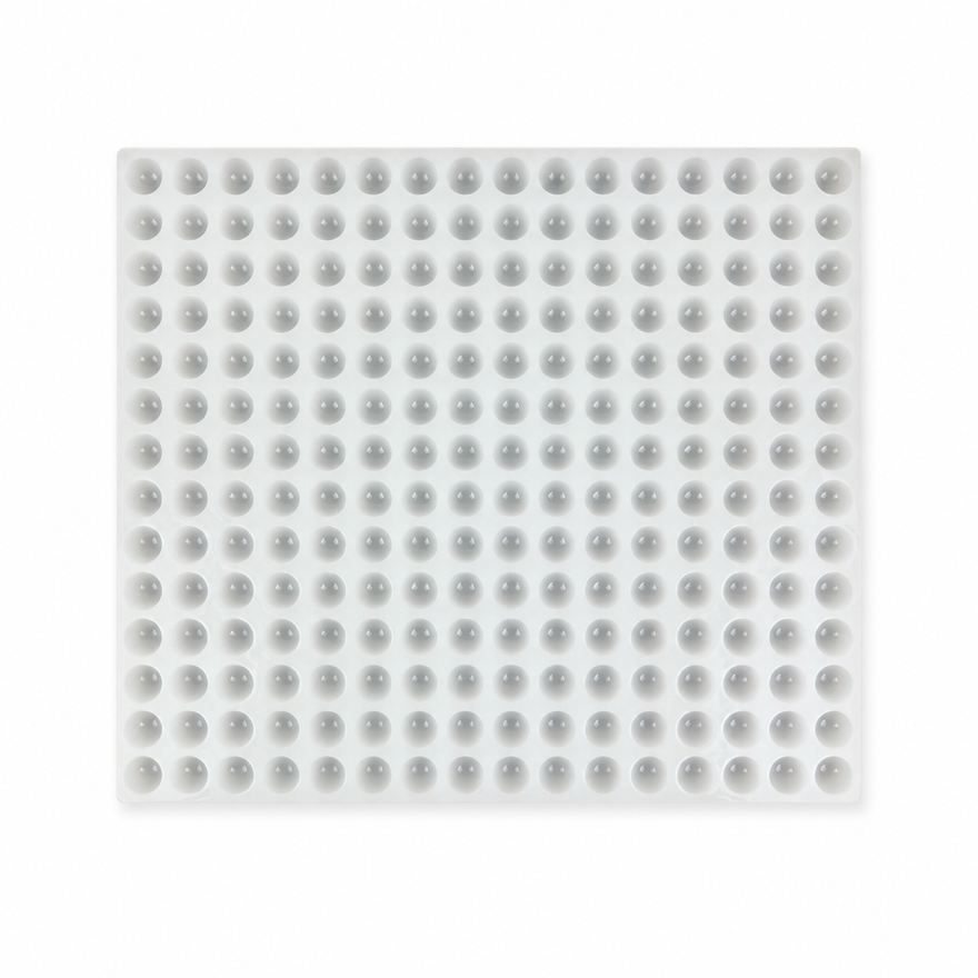 Commercial silicone gummy mold with 192 half-sphere cavities on a white background