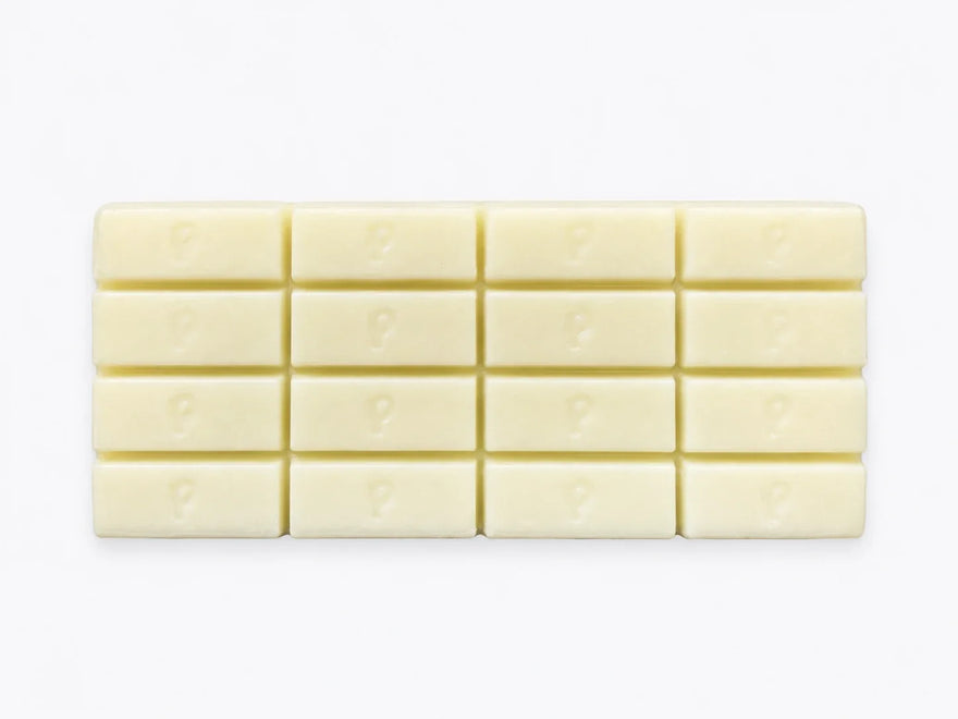Finished custom white chocolate bar showing branded logo detail