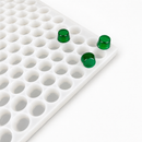 Close-up of a 3mL gumdrop gummy mold with 262 cavities and emerald green gummies on a white background