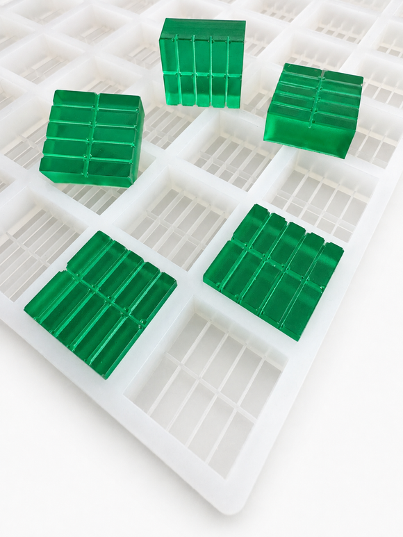 Close-up of 7.5mL 10-piece square breaker silicone gummy mold with translucent emerald green segmented gummies